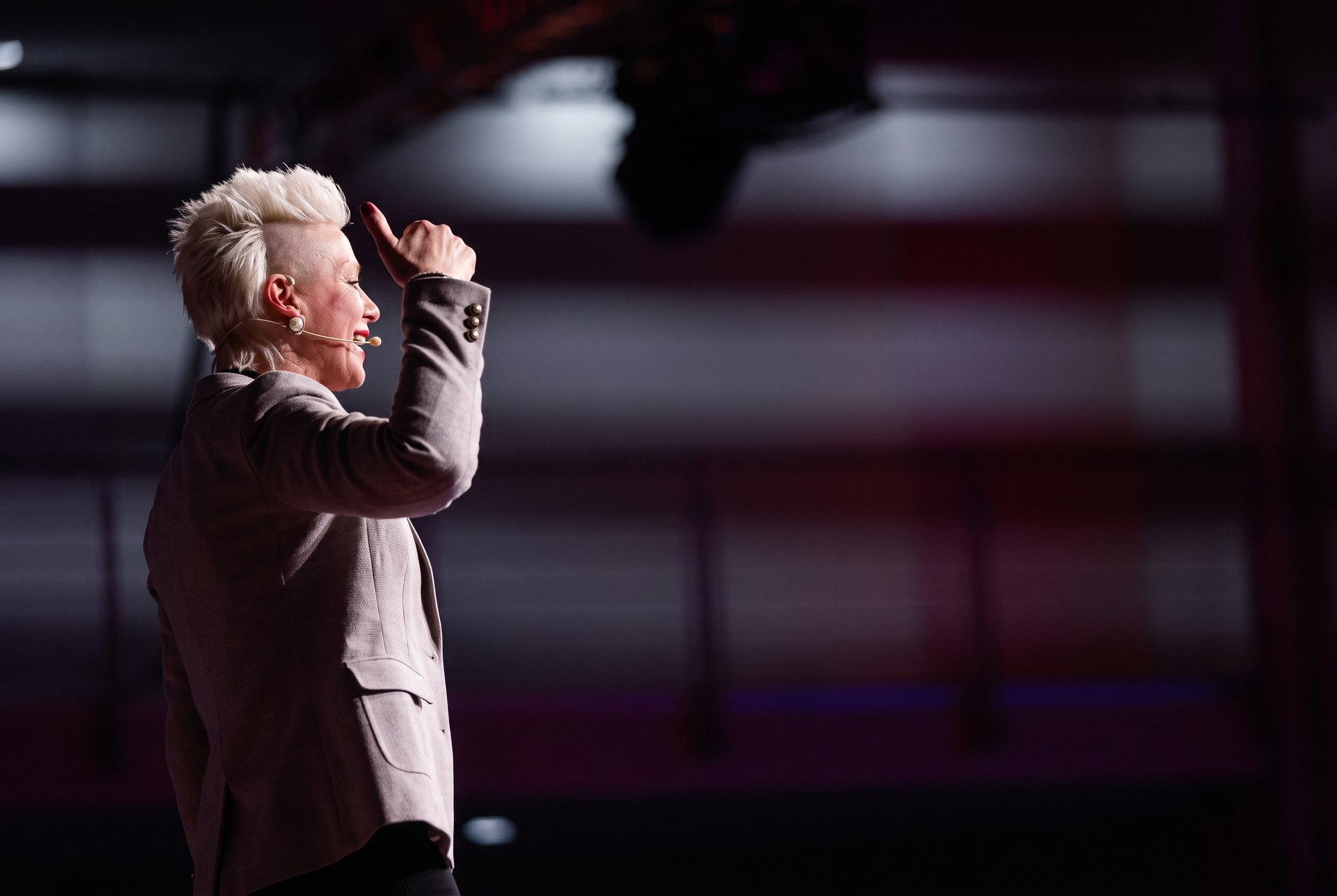 Brigitta Hoeferle speaking on stage at a TEDx event